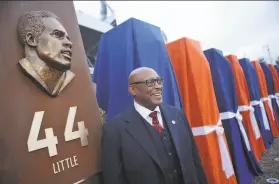  ?? Hyoung Chang / Denver Post via Getty Images 2013 ?? Hall of Fame running back Floyd Little, with his sculpture at the Denver Broncos’ Ring of Fame Plaza, rushed for 6,323 yards and 43 touchdowns.