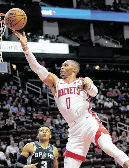  ?? Melissa Phillip / Staff photograph­er ?? Guard Russell Westbrook goes to the basket in his first action with the Rockets at Toyota Center.