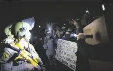  ?? ASSOCIATED PRESS ?? PROTESTERS CLASH WITH DEPUTIES of the Los Angeles Sheriff’s Department during protests following the death of Dijon Kizzee on Monday in Los Angeles.