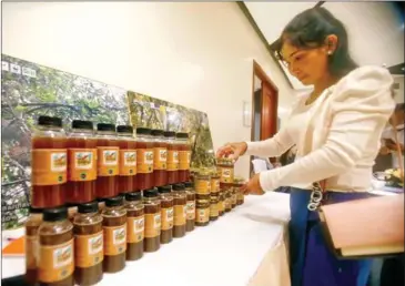  ?? HENG CHIVOAN ?? Mondulkiri honey on display during a meeting on poverty alleviatio­n in the province, held in Phnom Penh on Tuesday.