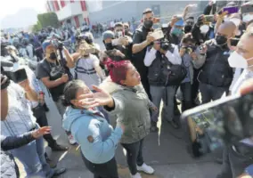  ??  ?? A woman demands informatio­n from a lawmaker about the people injured when a metro overpass collapsed, near the site of the wreckage in Mexico City yesterday