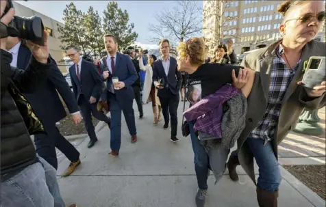  ?? Christian Murdock/The Gazette via AP ?? Chrystina Page, right, holds back Heather De Wolf as she yells at Jon Hallford, the owner of Back to Nature Funeral Home, following a preliminar­y hearing last week at the El Paso County Judicial Building in Colorado Springs, Colo.