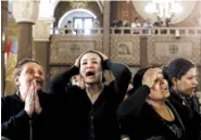  ?? THE ASSOCIATED PRESS ?? Women cry at the Mar Amina church Monday during the funeral for those killed in the Palm Sunday church attack in Alexandria, Egypt.