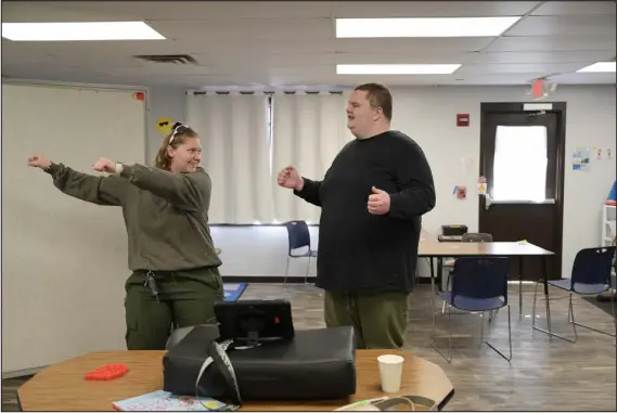  ?? HYOUNG CHANG — THE DENVER POST ?? Registered behavior technician Sadie Kearns leads Ethan Ortengren, 16, in a dance while working with him at Seven Dimensions Behavioral Health in Evergreen on Wednesday.