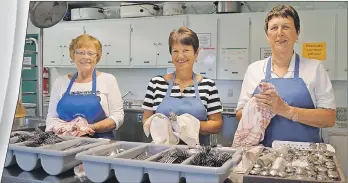  ?? JULIE COLLINS/CAPE BRETON POST ?? From left, Jean Viva, Pauline MacLeod and Agnes Gaskell, members of St. Joseph’s CWL in Bras d’Or, were busy recently preparing the kitchen for Wednesday’s turkey dinner.