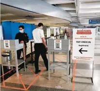  ??  ?? A pilot is checked in for a COVID-19 test at Doctors Test Centers on Thursday at O’Hare.