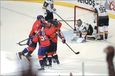  ?? PABLO MARTINEZ MONSIVAIS / AP ?? Washington Capitals captain Alex Ovechkin (8) joins the celebratio­n after linemate TJ Oshie’s goal against the Vegas Golden Knights in Game 4 of the Stanley Cup final on Monday. The Capitals won 6-2 to grab a 3-1 series lead.