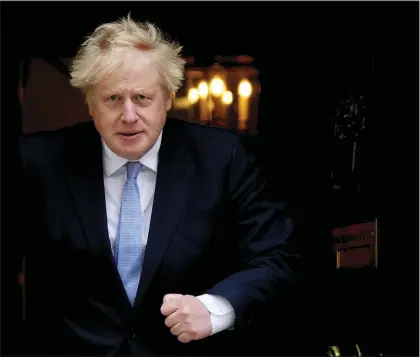  ?? FRANK AUGSTEIN — THE ASSOCIATED PRESS FILE ?? Britain’s Prime Minister Boris Johnson walks out the door to meet Norwegian Prime Minister Jonas Gahr Store at 10 Downing Street in London, Friday, May 13, 2022. Johnson is heading to Northern Ireland on Monday, May 16, 2022to try to end a political deadlock that is preventing the formation of a regional administra­tion.