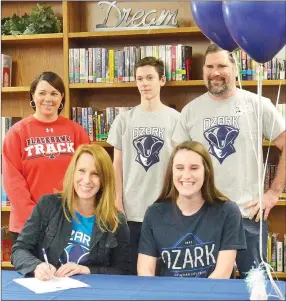  ?? TIMES photograph by Annette Beard ?? Lady Blackhawk Emma Stein was joined by her parents Jon and Beth Stein and brother Jacob Thursday as she celebrated signing a letter of intent to Ozark Christian College, Joplin, Mo., to run cross country.