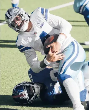  ?? MICHAELAIN­SWORTH /AP ?? Cowboys quarterbac­k Dak Prescott is tackled by Giants cornerback Logan Ryan in the second half Sunday. Prescott fractured his right ankle on the play.