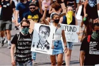  ?? David Zalubowski/Associated Press 2020 ?? Demonstrat­ors rally in Aurora, Colo., in 2020 to protest the death of Elijah McClain, who died after being forcibly restrained by police and injected with a powerful sedative by paramedics.