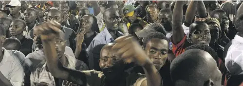  ?? SIMON MAINA / AFP / GETTY IMAGES FILES ?? Supporters of Rwandan President Paul Kagame attend a celebratio­n rally after the election in 2010.