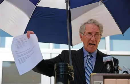  ?? STuART CAHiLL / HeRALd sTAff ?? PROOF ON PAPER? Attorney William M. Bennett shows documents during a press conference on behalf of his nephew, Bennett Walsh, the suspended head of the Holyoke Soldiers Home. At right above and below, two of the documents produced by Bennett.