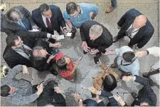  ?? JACQUELYN MARTIN THE ASSOCIATED PRESS ?? Speaker of the House Kevin McCarthy, top second from right, is encircled by reporters as he talks about the debt limit negotiatio­ns at the Capitol in Washington.