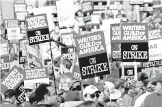  ?? — Reuters file photo ?? Thousands of Writers Guild of America members and supporters hold signs during a large strike in Los Angeles, California, on Nov 9, 2007.