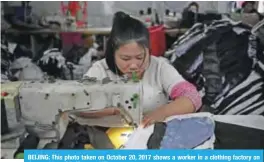  ??  ?? BEIJING: This photo taken on October 20, 2017 shows a worker in a clothing factory on the outskirts of Beijing. — AFP