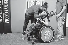  ?? [PHOTO BY BRYAN TERRY, THE OKLAHOMAN] ?? Energy FC goalkeeper Cody Laurendi plants a kiss on the head of Sidekick buddy Jackson Wells during an event last month in Oklahoma City.