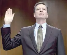  ?? — AFP file photo ?? This photo taken on May 3, 2017 shows then FBI director James Comey being sworn in prior to testifying before the Senate Judiciary Committee on Capitol Hill in Washington, DC.