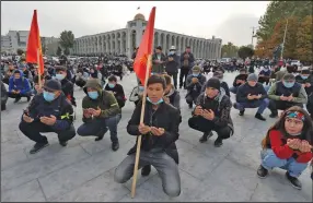  ?? (AP/Vladimir Voronin) ?? Protesters pray during an opposition rally Friday on the central square in Bishkek, Kyrgyzstan.