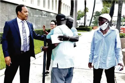  ?? LEWIS M. LEVINE/ASSOCIATED PRESS ?? Marcus Arbery (middle), father of Ahmaud Arbery, arrived at the federal courthouse Monday for the sentencing hearings.