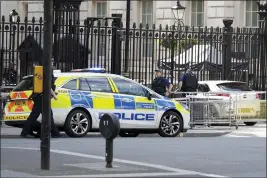  ?? ALASTAIR GRANT — THE ASSOCIATED PRESS ?? Police are at the scene Thursday after a car collided with the gates of Downing Street in London.