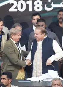  ??  ?? Pakistani Chief Minister of Punjab Province Shahbaz Sharif, left, shakes hands with his brother and ousted Prime Minister Nawaz Sharif after being elected president of the ruling Pakistan Muslim League-Nawaz (PML-N) party at the General Council in...