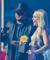  ?? MARK HUMPHREY/AP ?? Jason Aldean and Carrie Underwood accept a trophy at the CMT Music Awards on Monday.