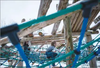  ?? Canadian Press photo ?? Tate Ottahal, 10, climbs across a rope net on a wood playground at Rochester Park in Coquitlam, B.C., last week.