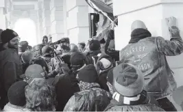  ?? JOSE LUIS MAGANA AP ?? Insurrecti­onists loyal to President Donald Trump try to open a door of the U.S. Capitol as they riot in Washington on Jan. 6.