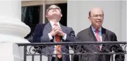  ??  ?? WASHINGTON: US Attorney General Jeff Sessions, left, looks up at the partial solar eclipse with Commerce Secretary Wilbur Ross from the balcony of the White House in Washington, DC. — AFP