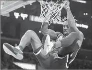  ?? Luis Sinco Los Angeles Times ?? DWIGHT HOWARD HANGS on the rim during another strong game: 15 points and eight rebounds.