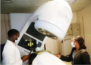  ??  ?? Doctors attend to a patient on a radiothera­py machine at Mpilo Hospital yesterday