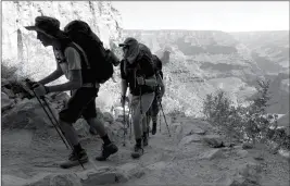  ?? ASSOCIATED PRESS ?? IN THIS 2015 FILE PHOTO, a long line of hikers head out of the Grand Canyon along the Bright Angel Trail at Grand Canyon National Park, Ariz. Authoritie­s have seen a big increase in search and rescue missions in northern Arizona, driven by a surge in...
