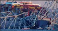  ?? KARL MERTON FERRON — THE BALTIMORE SUN ?? Emergency boats float around a container ship whose bow received damage after the Francis Scott Key Bridge crumbled onto the vessel and into the Patapsco River following a collision with the structure overnight.