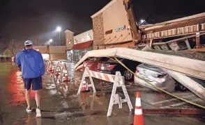  ?? TOM FOX/THE DALLAS MORNING NEWS VIA AP ?? The roof of a grocery store was peeled off as a line of powerful storms on Thursday rolled through Little Elm, Texas.