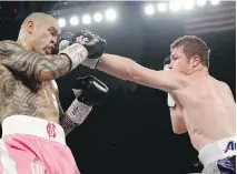  ?? JOHN LOCHER/THE ASSOCIATED PRESS ?? Miguel Cotto, left, is hit by Canelo Alvarez, who won the WBC middleweig­ht title bout Saturday in Las Vegas.