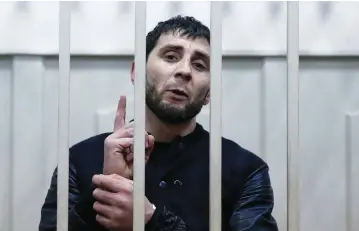  ?? (Tatyana Makeyeva/Reuters) ?? ZAUR DADAYEV, charged with involvemen­t in the slaying of Russian opposition figure Boris Nemtsov, speaks inside a defendants’ cage at a court in Moscow on Sunday.