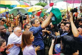  ?? AP PHOTO BY NELSON ANTOINE ?? Workers' Party presidenti­al candidate Fernando Haddad holds a Brazilian flag after casting his vote in the presidenti­al election in Sao Paulo, Brazil, Sunday, Oct. 28.