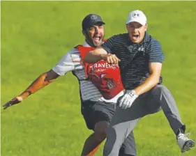  ??  ?? Jordan Spieth, a 23-year-old Texan, celebrates Sunday with caddie Michael Greller after chipping in for a birdie from a bunker on the 18th green to win the Travelers Championsh­ip in a playoff against Daniel Berger. Maddie Meyer, Getty Images