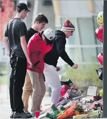  ?? NICK PROCAYLO ?? Abbotsford Senior Secondary School students grieve and contribute to a memorial the day after 13-year-old Letisha Reimer was stabbed to death in Abbotsford last week.