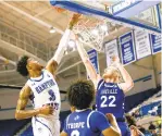  ?? JOHN SUDBRINK/ FREELANCE FILE ?? Hampton standout Davion Warren and
UNC Asheville forward Coty Jude fight for a loose ball at the HU Convocatio­n Center in February 2020. Warren and the Pirates seek to extend their season tonight.