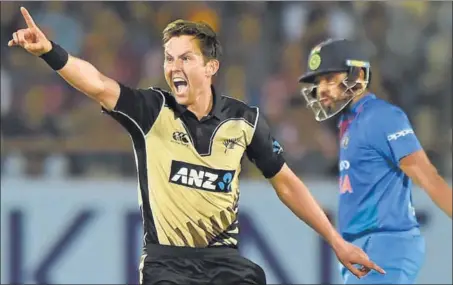  ?? AFP ?? Trent Boult (left) appeals successful­ly to have Rohit Sharma caught behind during the second T20I in Rajkot on Saturday. New Zealand won by 40 runs.