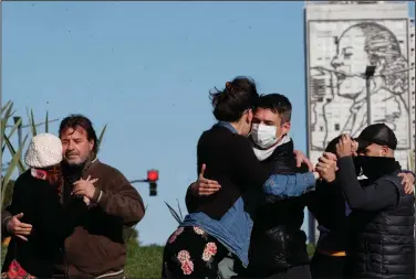  ?? (AP/Natacha Pisarenko) ?? Couples dance a tango during a protest Tuesday in Buenos Aires to call for permission to perform in open spaces. Since the pandemic hit Argentina last year, tango dancing, an essential part of Argentine culture, has been suspended as a precaution against the spread of the coronaviru­s.