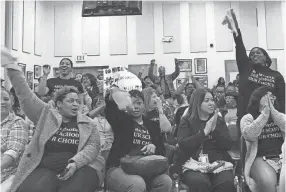  ?? LAURA FAITH KEBEDE ?? Supporters celebrate a unanimous vote from the Shelby County Schools board to keep open three charter schools.