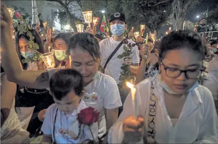  ?? LAUREN DECICCA / GETTY IMAGES ?? Myanmar nationals hold a candleligh­t vigil Thursday outside of the United Nations headquarte­rs in Bangkok, Thailand, in remembranc­e of 38 anticoup protesters who have been killed.