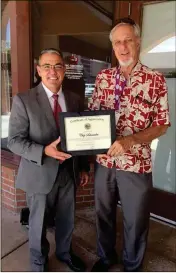  ?? LOANED PHOTO ?? YUMA COUNTY ATTORNEY JON SMITH (left) presents Chip Schneider with a certificat­e of appreciati­on for his dedication to the children in the county and his work as children’s justice project coordinato­r. Schneider recently retired from his position at...