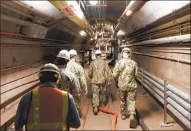  ?? Mass Communicat­ion Spc. 1st Class Luke McCall U.S. Navy ?? REAR ADM. John Korka leads Navy and civilian experts through the tunnels of the Red Hill Bulk Fuel Storage Facility, a set of 20 tanks near Pearl Harbor.