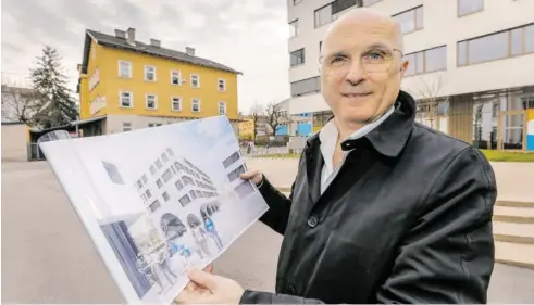  ?? BILD: SN/ROBERT RATZER ?? Architekt Alfred Berger zeigt die Pläne für den Neubau der PMU, der ähnlich luftig aussehen soll wie seine anderen Neubauten am Stadtwerke­areal (rechts). Das alte, gelbe Druckereig­ebäude soll noch im Sommer abgerissen werden.