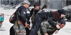  ??  ?? ALEPPO: A Syrian pro-government fighter carries a wounded woman who was reportedly shot by rebel sniper while fleeing with her family Aleppo’s eastern Al-Salihin neighborho­od yesterday after troops retook the area from rebel fighters. —AFP