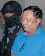  ?? NUTTHAWAT WICHEANBUT ?? Former deputy commerce minister Pol Lt Col Banyin Tangpakorn is arrested by CSD officers at his house in Nakhon Sawan’s Muang district yesterday.